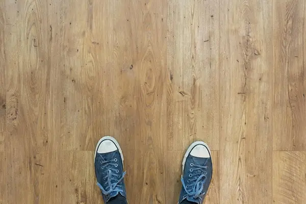 Two sneakers on a bare floor