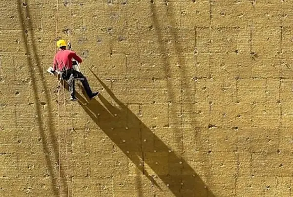 Person putting insulation on a wall