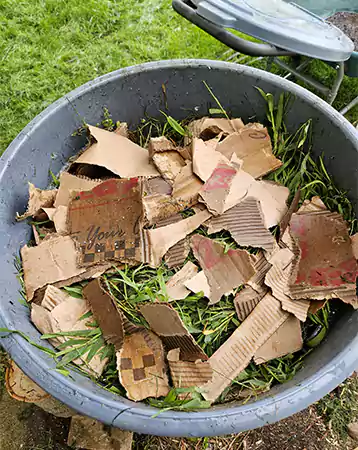 Mixing tough stalk and cardboard with compost