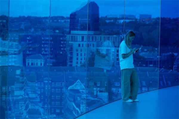 Person wiping a large interior window with a microfiber cloth