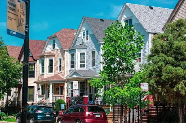 A row of brick two-story homes lining a quiet residential street in Chicago