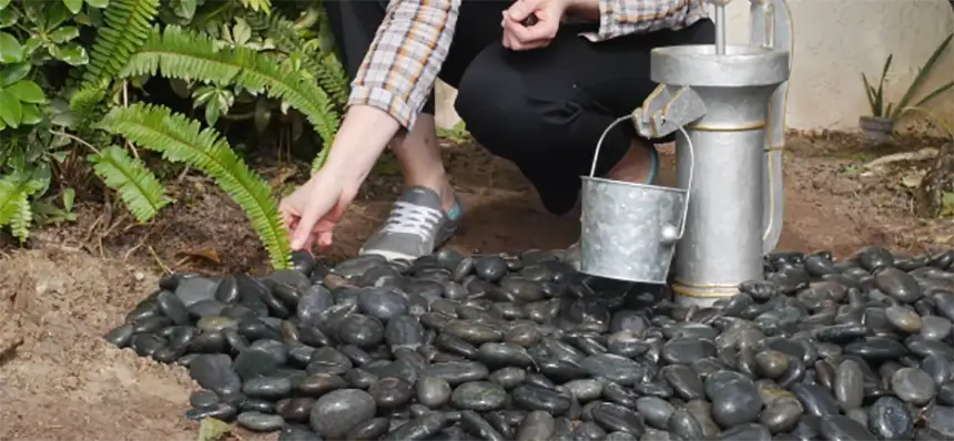 Decorate fountain with rocks and pebbles