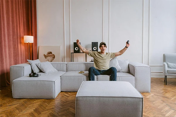 Excited Man on Cozy Sofa