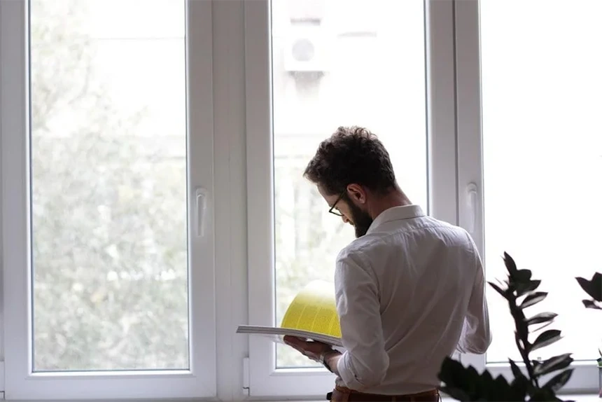 A property manager checking a tablet inside a high-end rental home