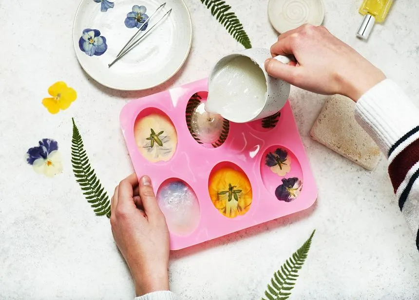 Clay being poured into a mold to create pressed flower art designs on it