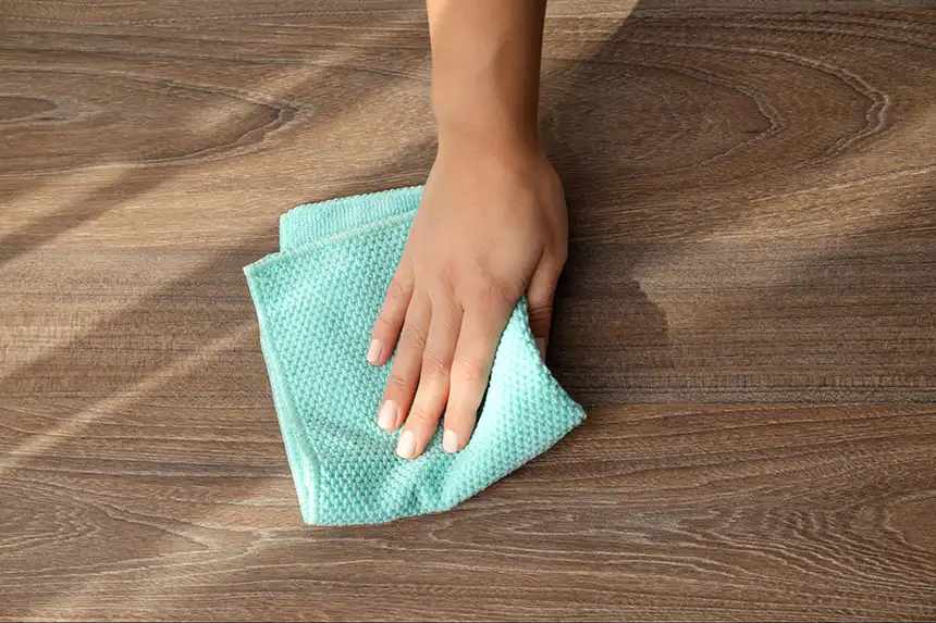 Using a towel to dry the floor